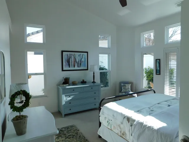 a bedroom with a bed and a night stand