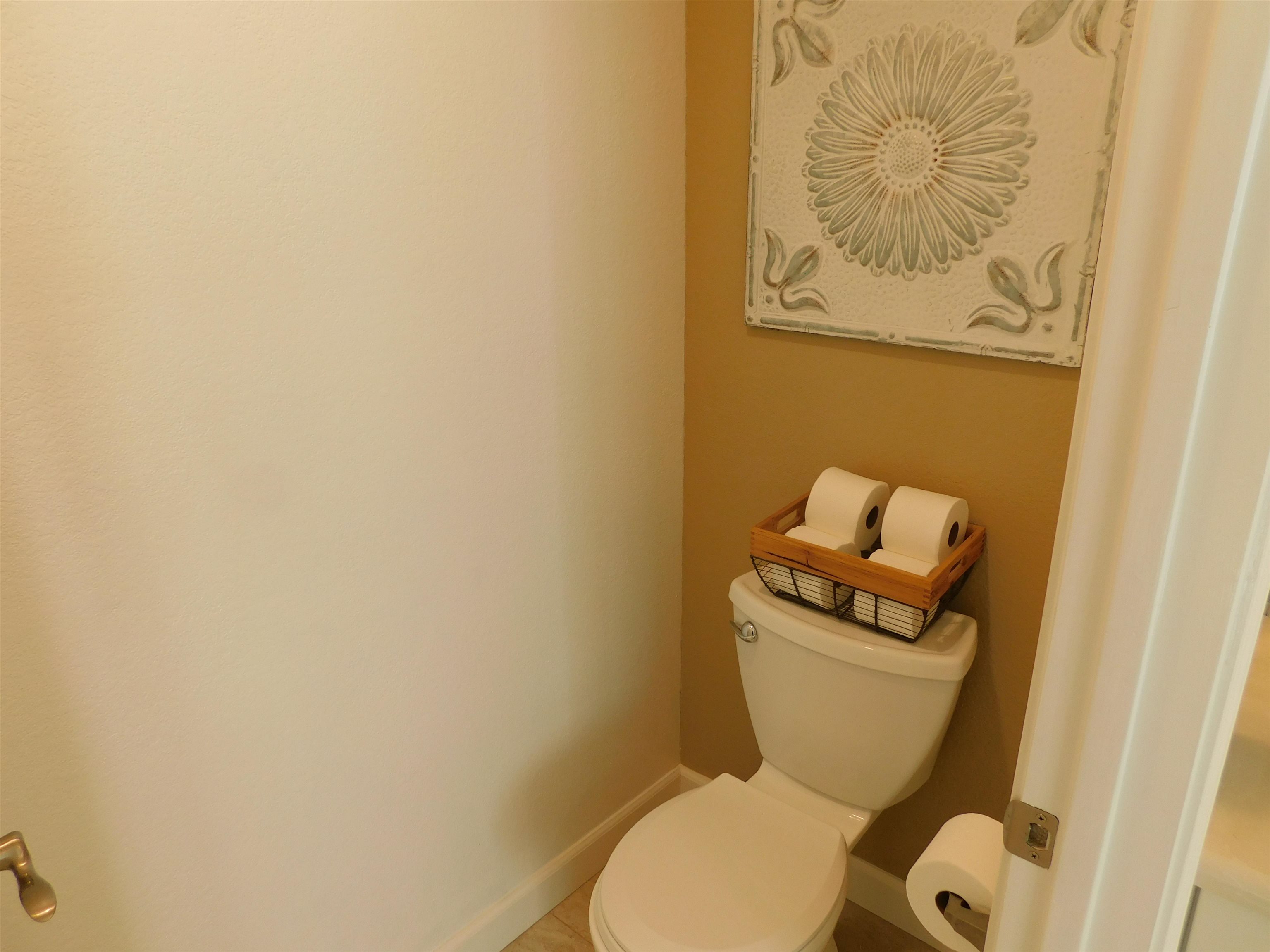 1169 Copper Cottage Lane Modesto, CA 95355 - Photo 21 of 42 a white toilet sitting next to a wooden wall