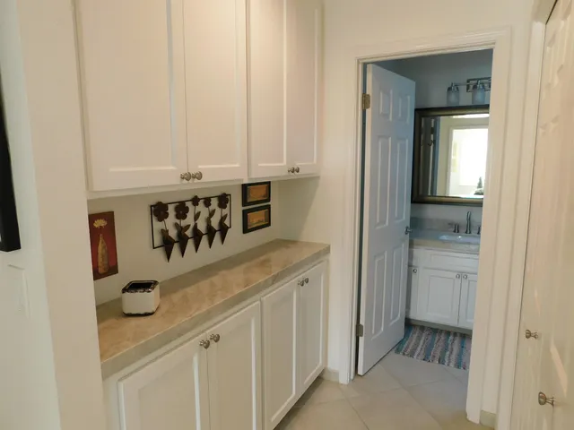 a bathroom with a granite countertop toilet a sink and a mirror