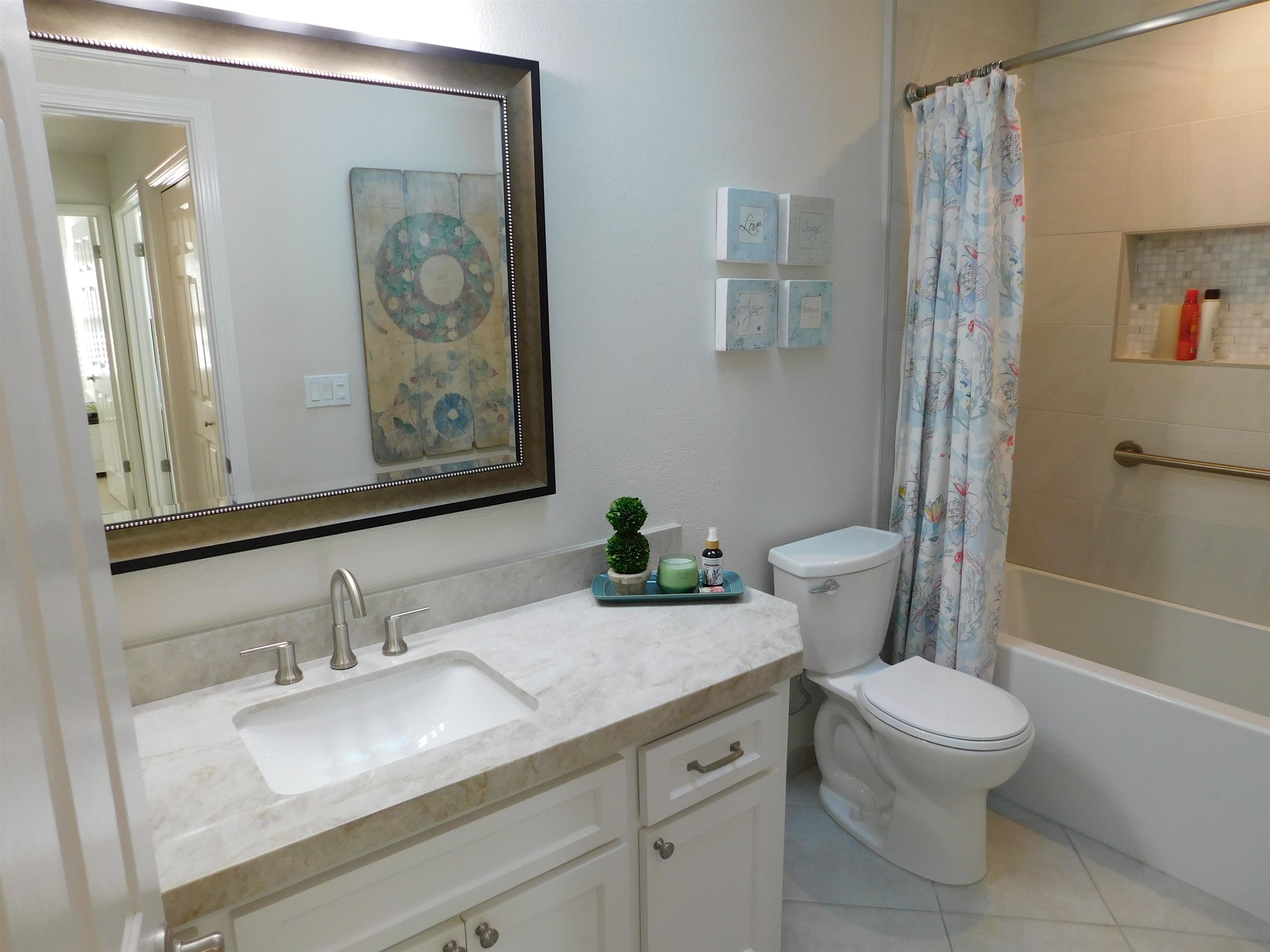 1169 Copper Cottage Lane Modesto, CA 95355 - Photo 26 of 42 a bathroom with a granite countertop toilet a sink and a mirror