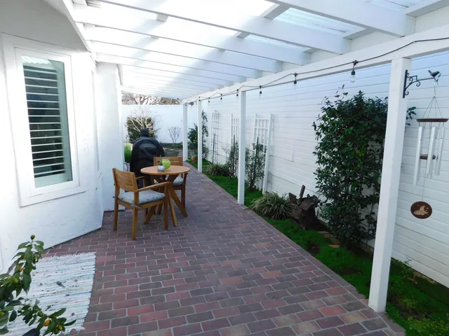 a view of a house with a garden and plants