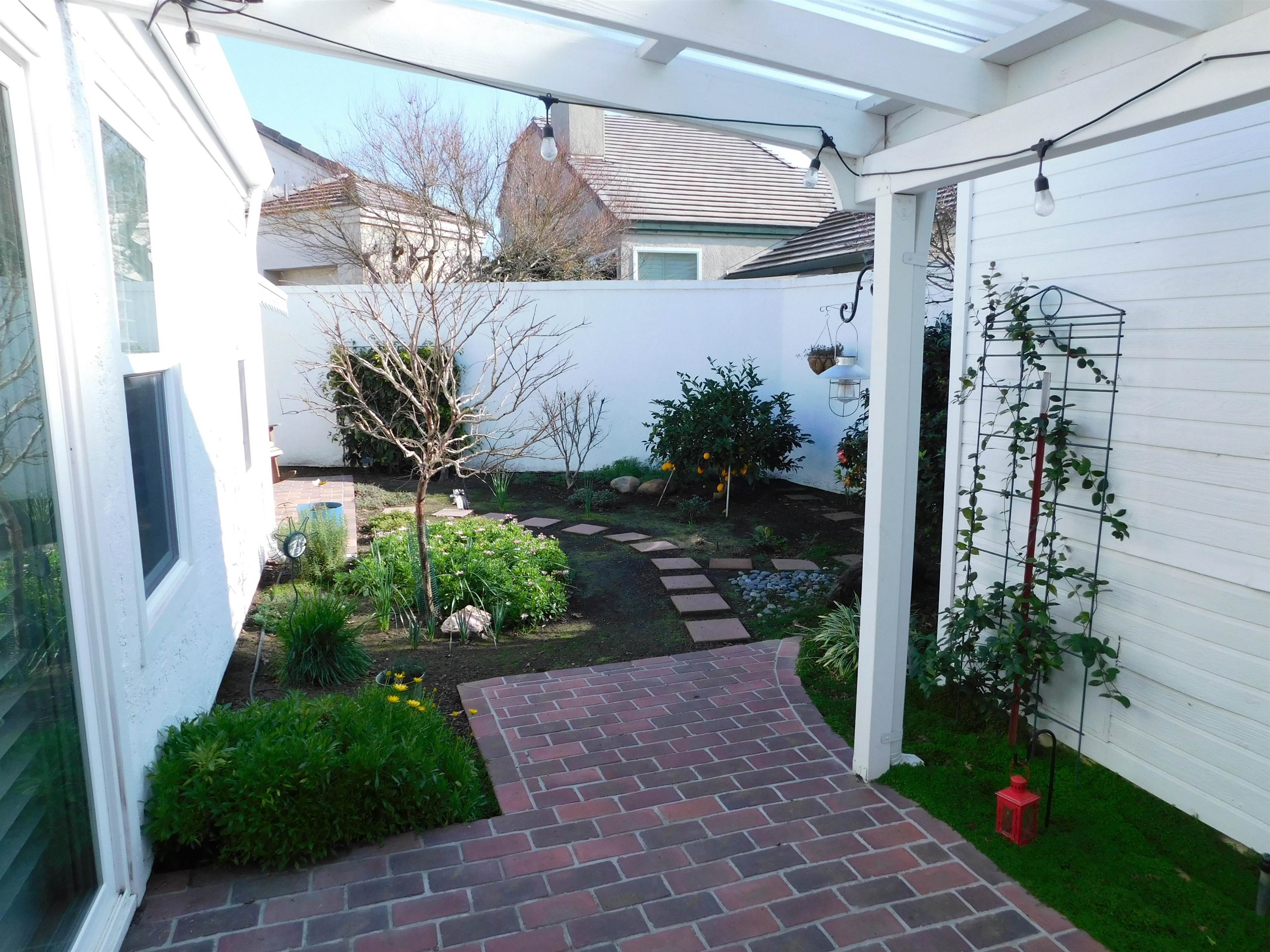 1169 Copper Cottage Lane Modesto, CA 95355 - Photo 29 of 42 a view of a house with a garden and plants
