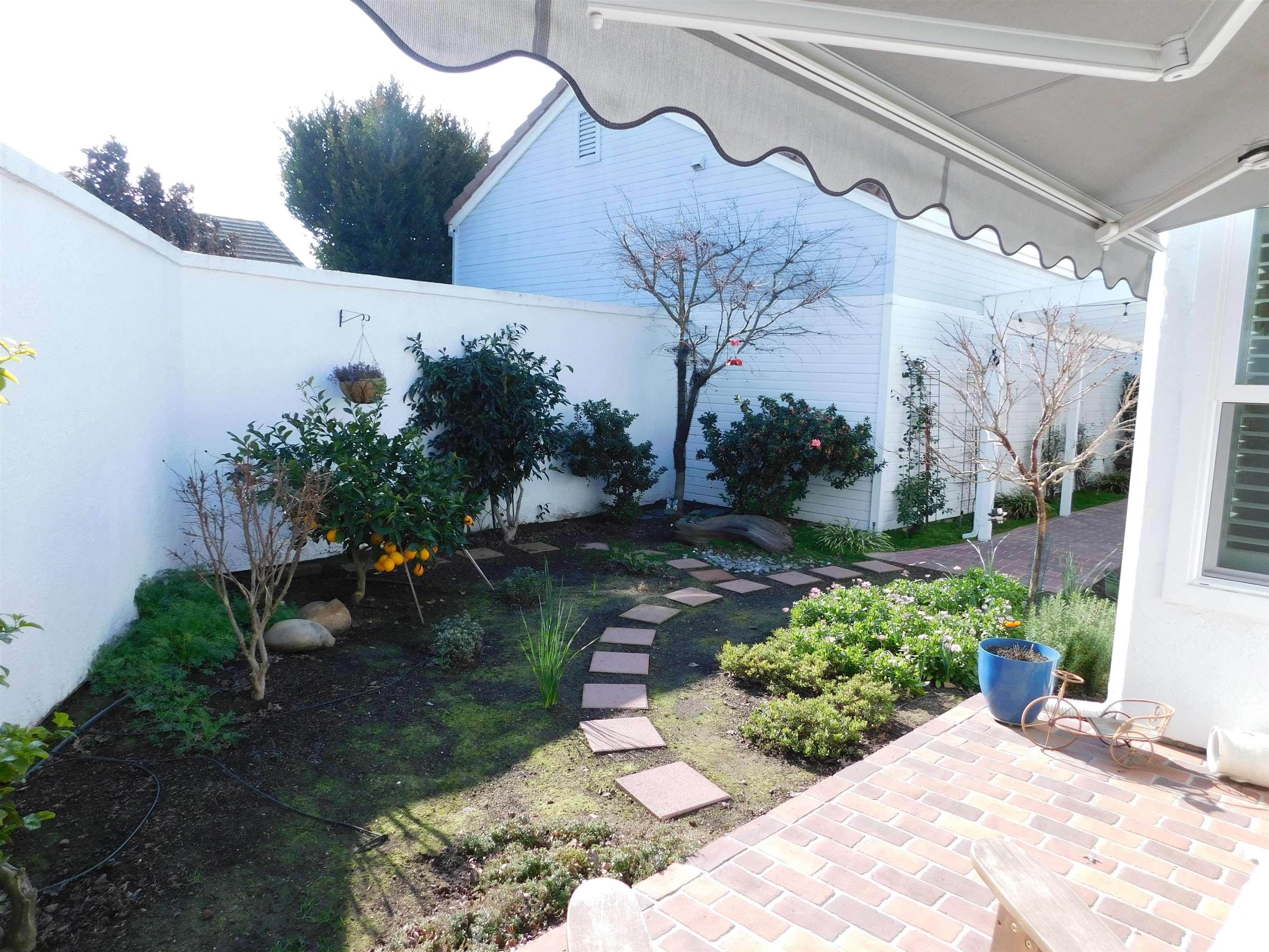 1169 Copper Cottage Lane Modesto, CA 95355 - Photo 32 of 42 a view of a house with a yard and a garden