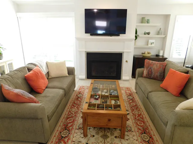 a living room with furniture flat screen tv and a fireplace