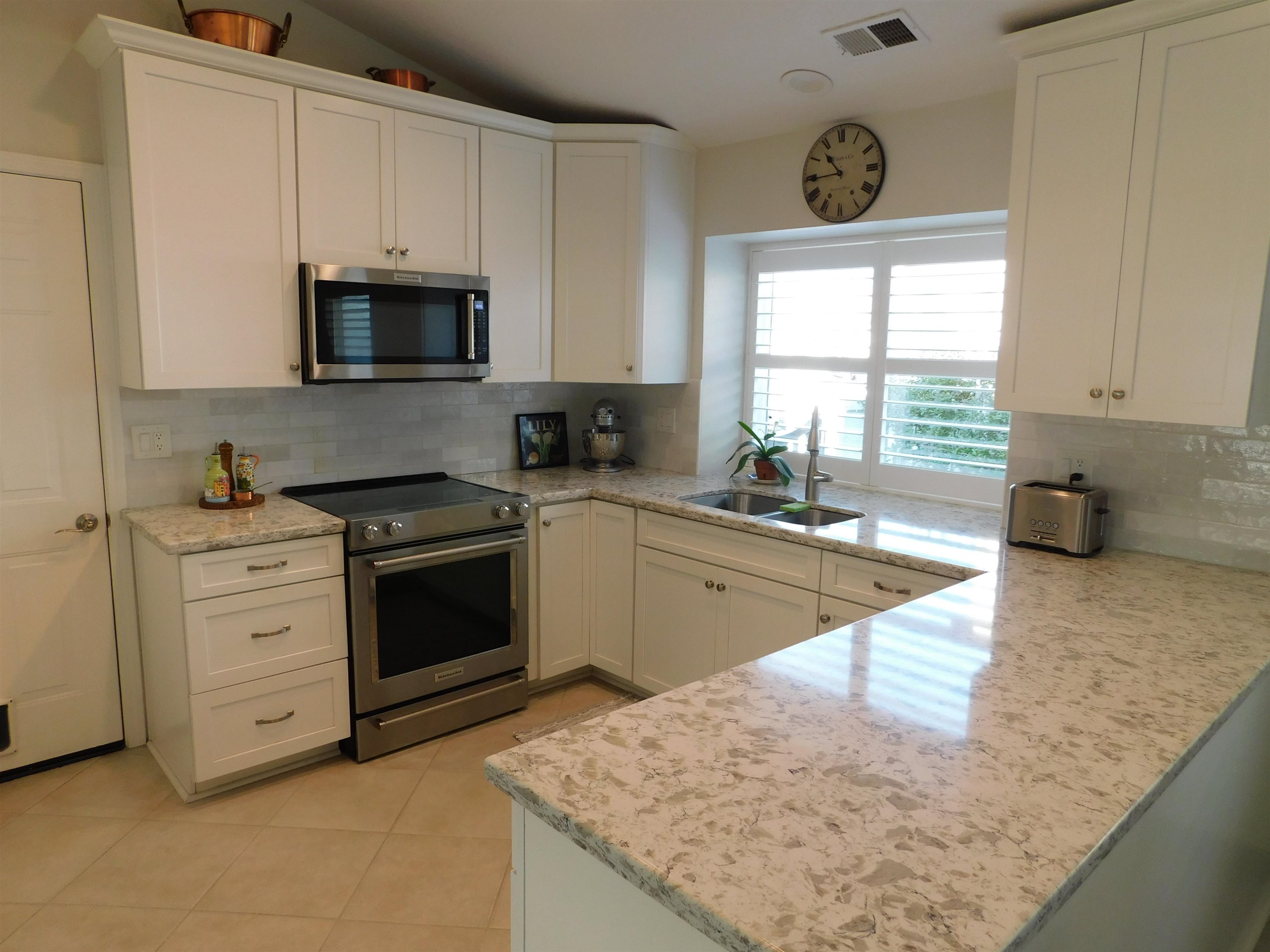 1169 Copper Cottage Lane Modesto, CA 95355 - Photo 9 of 42 a kitchen with stainless steel appliances granite countertop a sink a stove and a granite counter tops