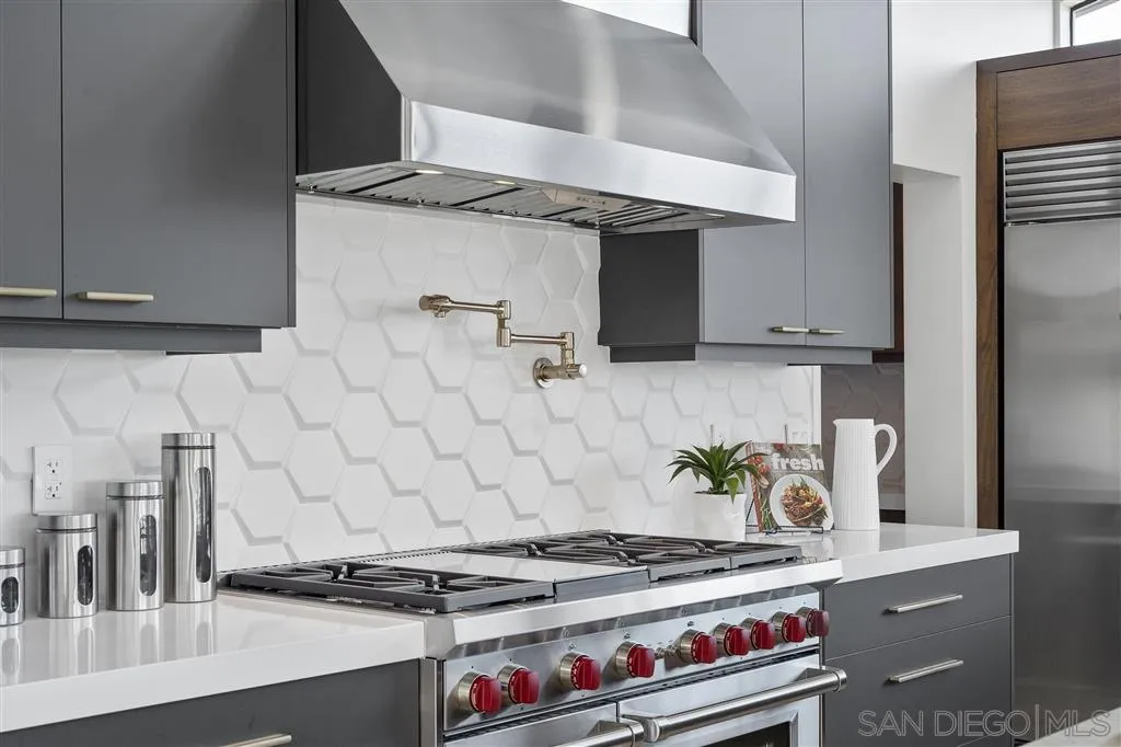 5780 Rutgers Road La Jolla, CA 92037 - Photo 11 of 25 a kitchen with granite countertop a stove and a refrigerator