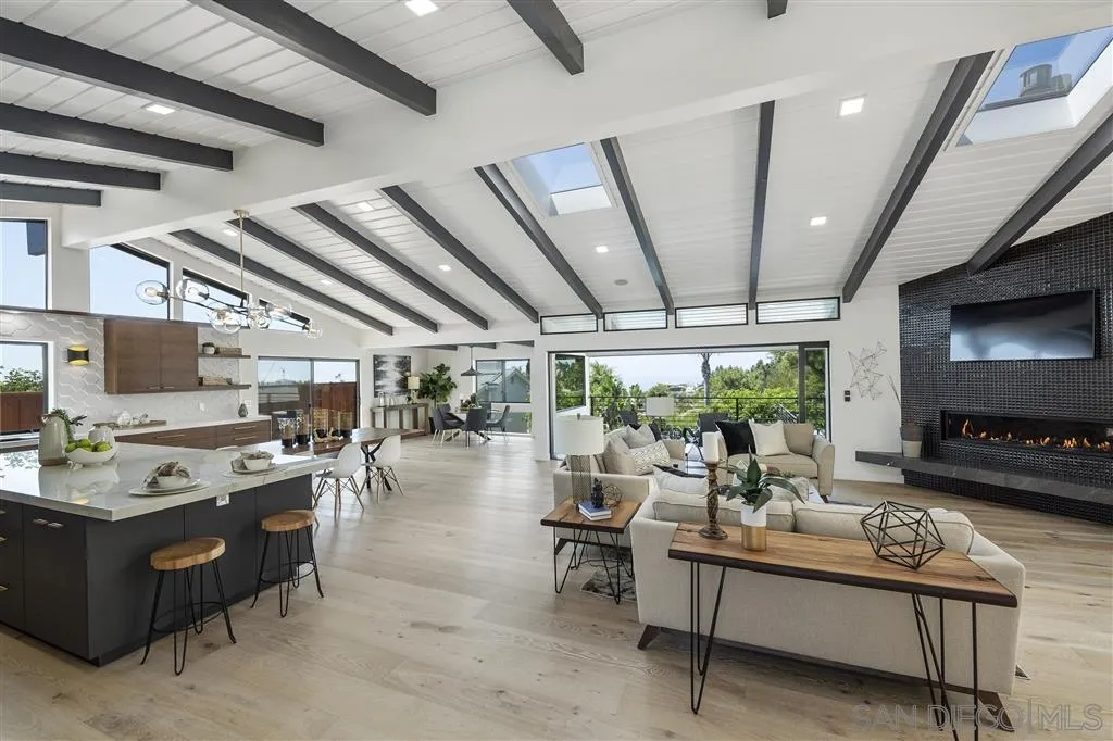 5780 Rutgers Road La Jolla, CA 92037 - Photo 12 of 25 a living room with lots of furniture and a flat screen tv