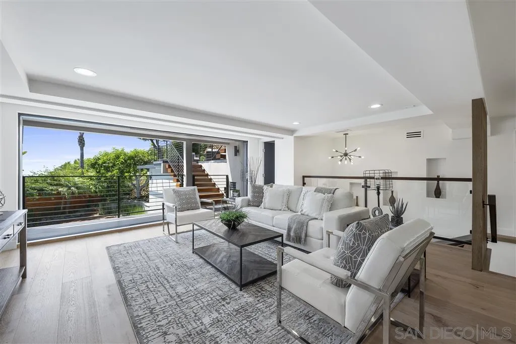 5780 Rutgers Road La Jolla, CA 92037 - Photo 20 of 25 a living room with furniture and a floor to ceiling window