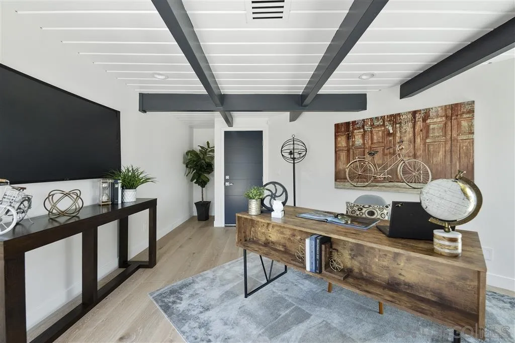 5780 Rutgers Road La Jolla, CA 92037 - Photo 24 of 25 a living room with furniture and a flat screen tv
