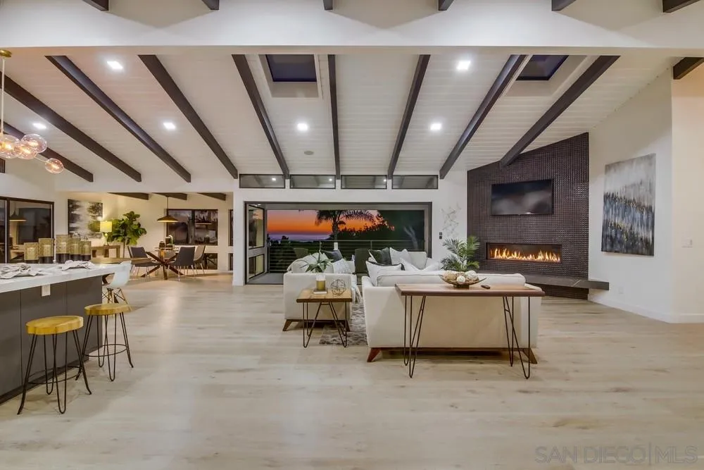 5780 Rutgers Road La Jolla, CA 92037 - Photo 4 of 25 a living room with lots of furniture and clutter