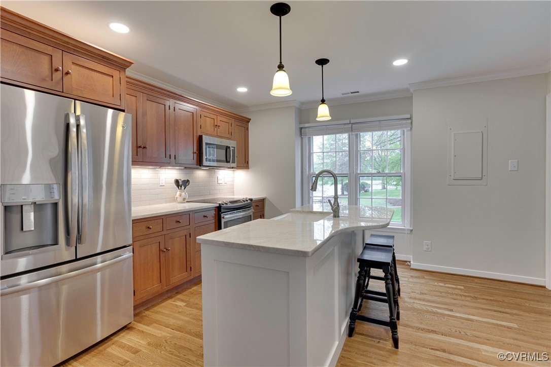 2706 Berkeley Pointe Drive Henrico, VA 23233 - Photo 16 of 48 a kitchen with stainless steel appliances a refrigerator a sink dishwasher a kitchen island with wooden cabinets and floor