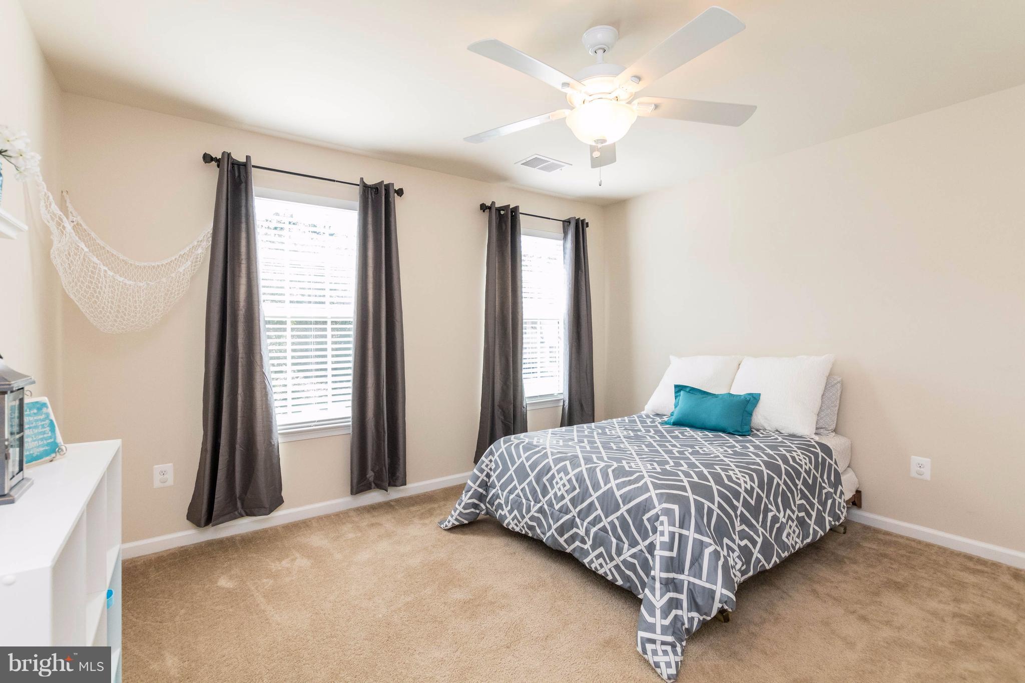 913 Gladway Road Baltimore, MD 21220 - Photo 22 of 30 a bedroom with a large bed and a chandelier