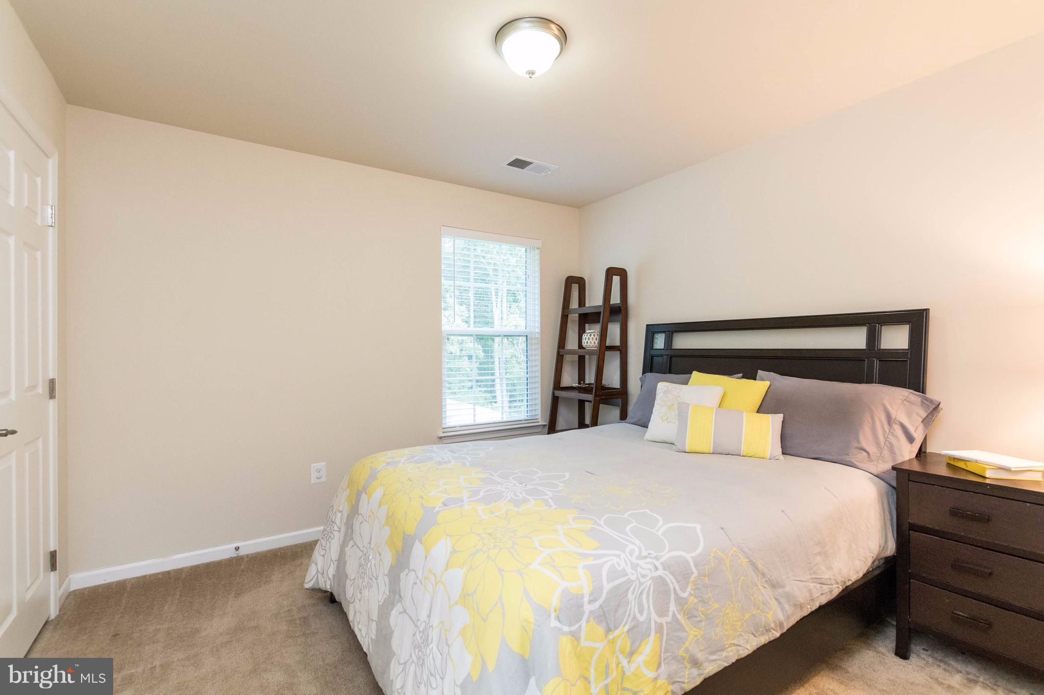 913 Gladway Road Baltimore, MD 21220 - Photo 23 of 30 a large bed sitting in a bedroom next to a lamp