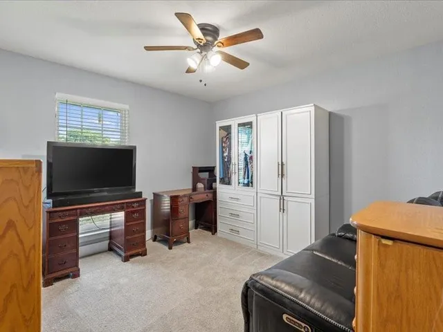 a view of a livingroom with furniture and a flat screen tv