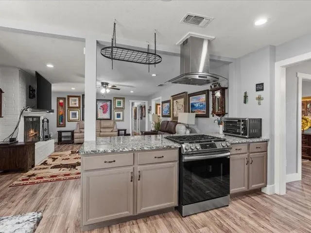 a kitchen with stainless steel appliances granite countertop a stove and a sink