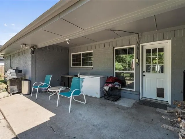 a view of a livingroom with furniture and floor to ceiling window