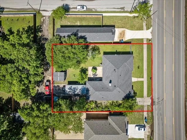 an aerial view of a house with a yard and a garden