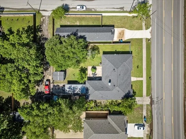 an aerial view of a house with a yard