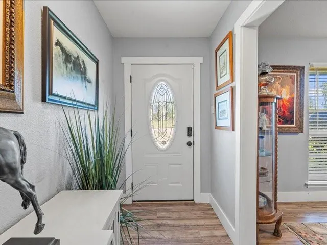 a view of an entryway with wooden floor