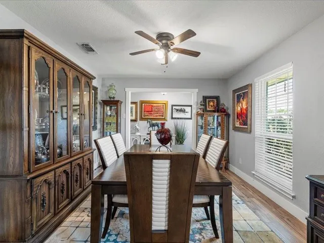 a dining room with furniture a rug and a large window