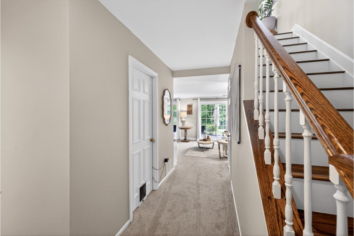 7347 Swan Point Way, Unit 122 Columbia, MD 21045 - Photo 29 of 54 a view of an entryway with wooden floor and stairs
