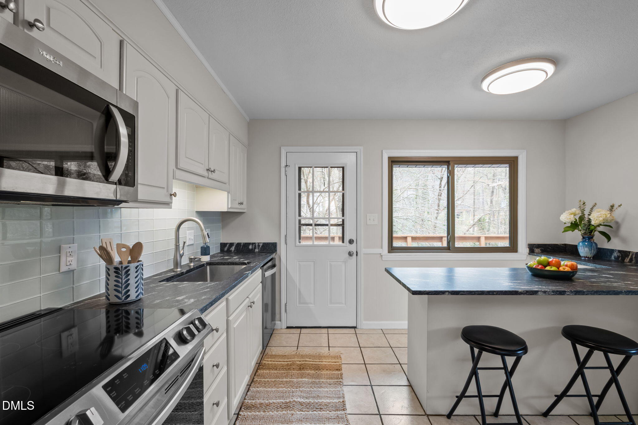 321 Brandywine Road Chapel Hill, NC 27516 - Photo 8 of 38 a kitchen with a stove a sink and a microwave