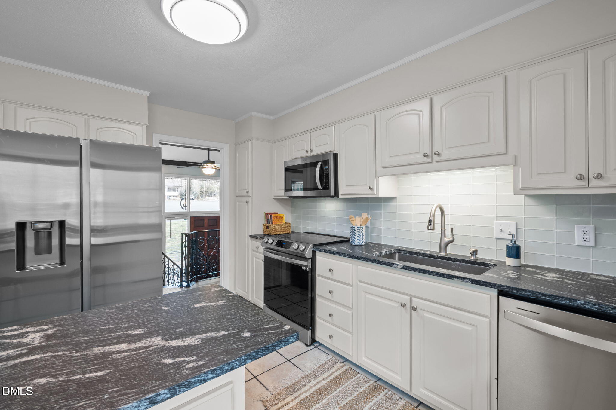 321 Brandywine Road Chapel Hill, NC 27516 - Photo 7 of 38 a kitchen with stainless steel appliances granite countertop a sink a stove top oven and refrigerator