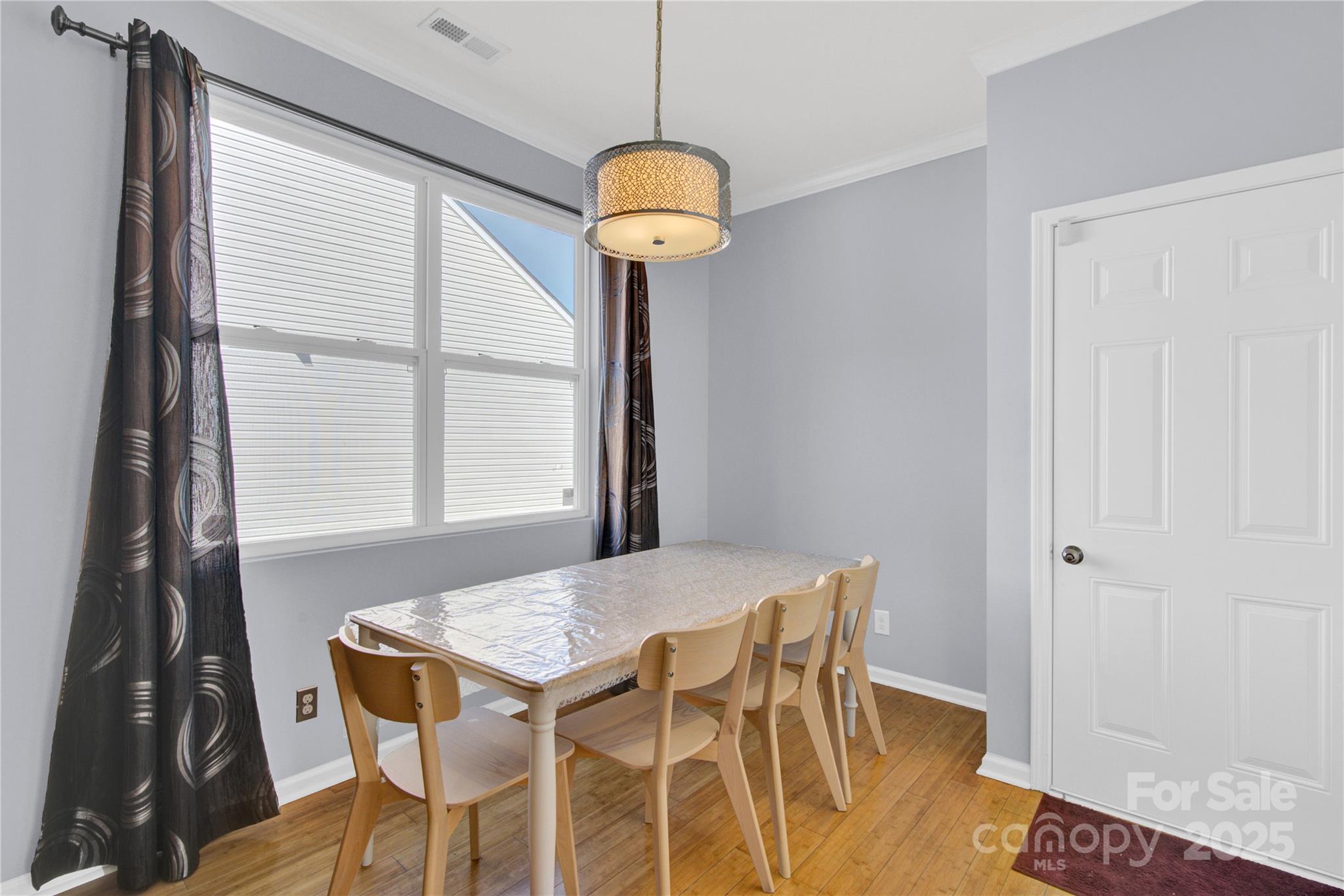 12418 Downy Birch Road Charlotte, NC 28227 - Photo 13 of 37 a view of a dining room with furniture and wooden floor