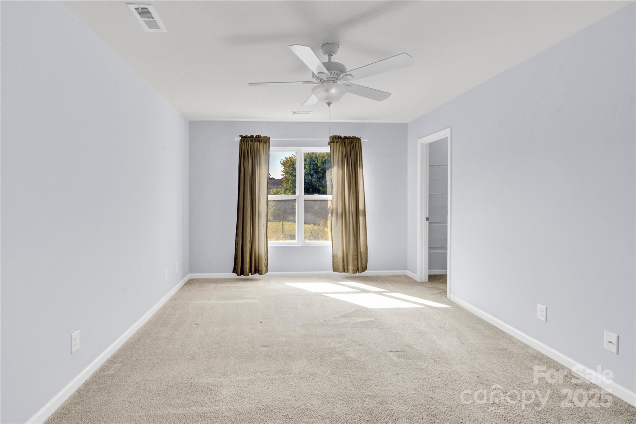 12418 Downy Birch Road Charlotte, NC 28227 - Photo 15 of 37 an empty room with a ceiling fan and window