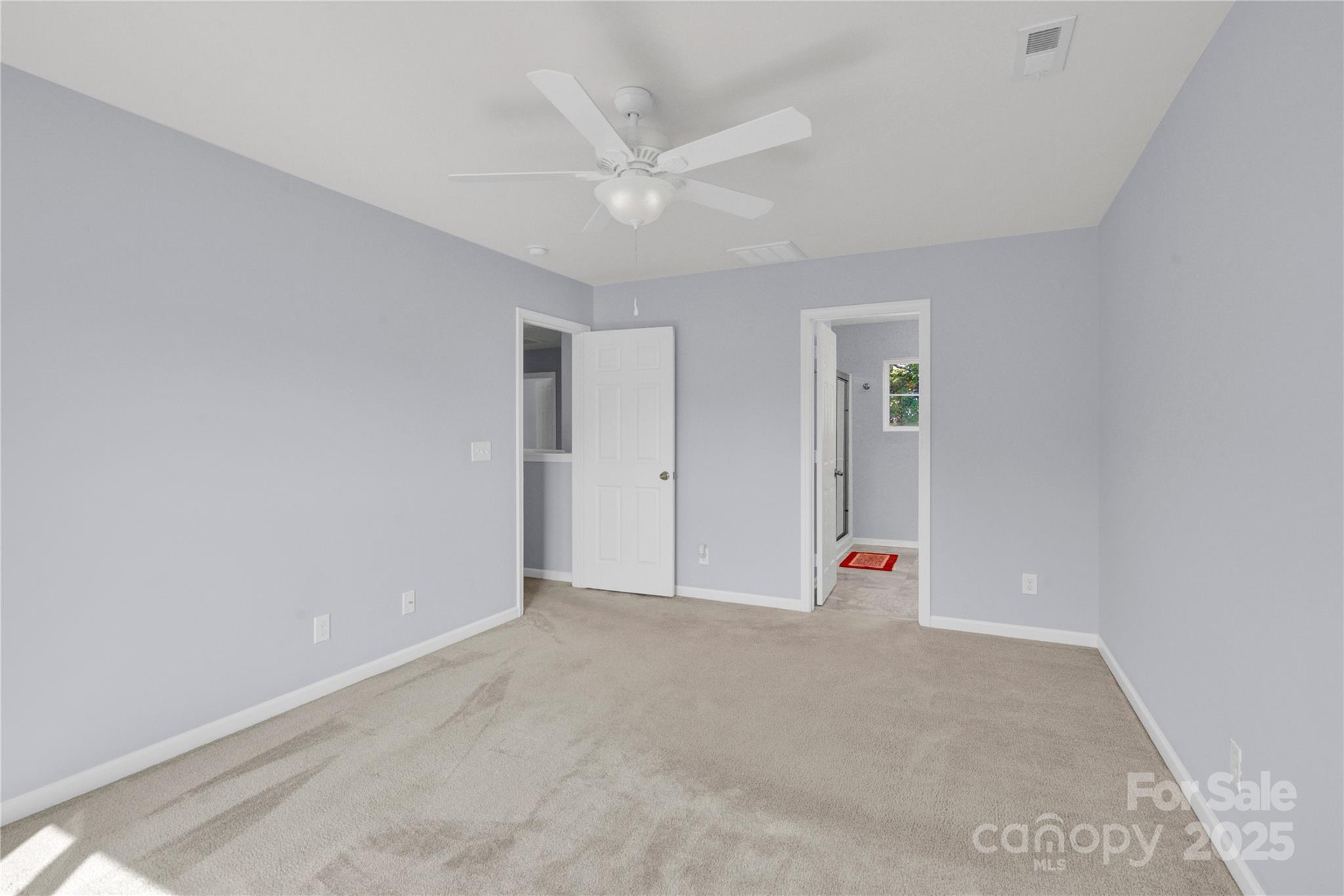 12418 Downy Birch Road Charlotte, NC 28227 - Photo 16 of 37 an empty room with an entryway and fan