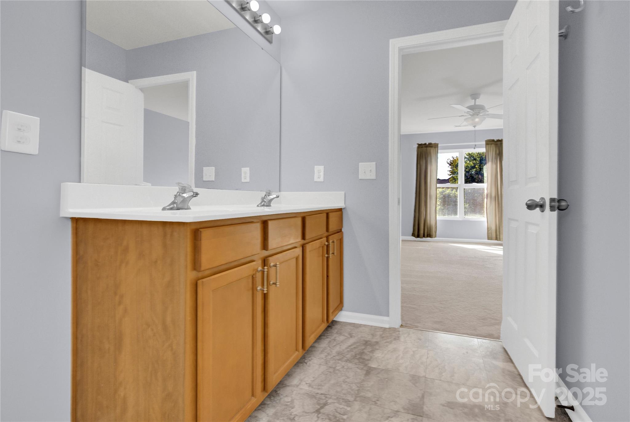 12418 Downy Birch Road Charlotte, NC 28227 - Photo 19 of 37 a bathroom with a sink a mirror and a vanity