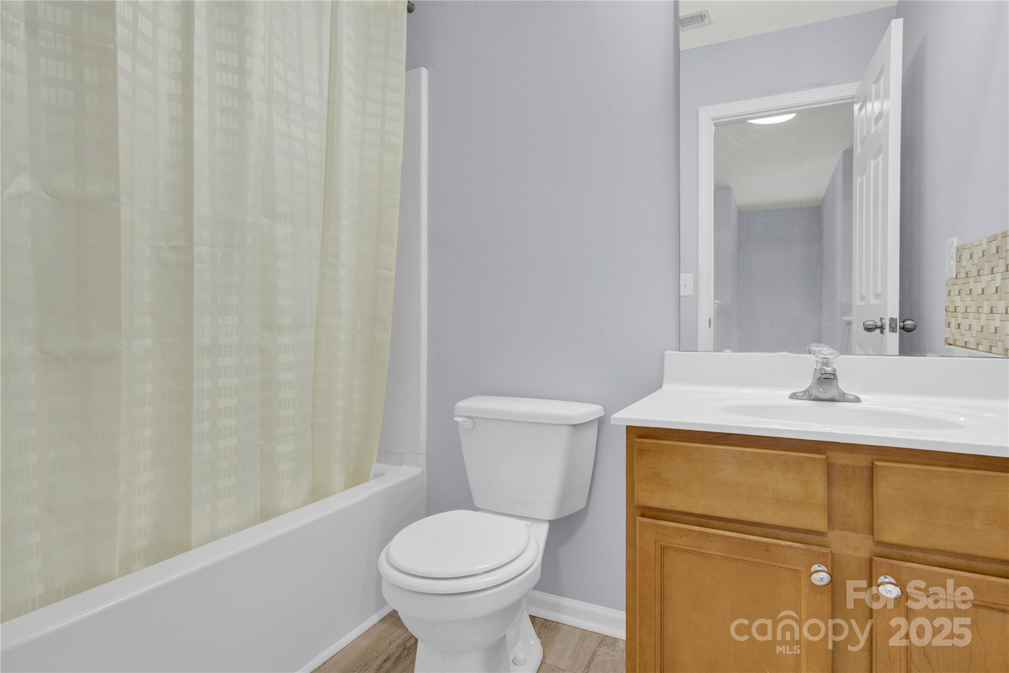12418 Downy Birch Road Charlotte, NC 28227 - Photo 25 of 37 a bathroom with a sink a toilet and shower curtain
