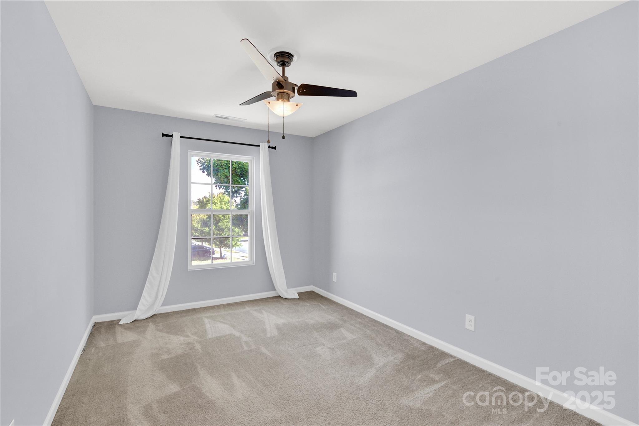 12418 Downy Birch Road Charlotte, NC 28227 - Photo 28 of 37 an empty room with windows and fan