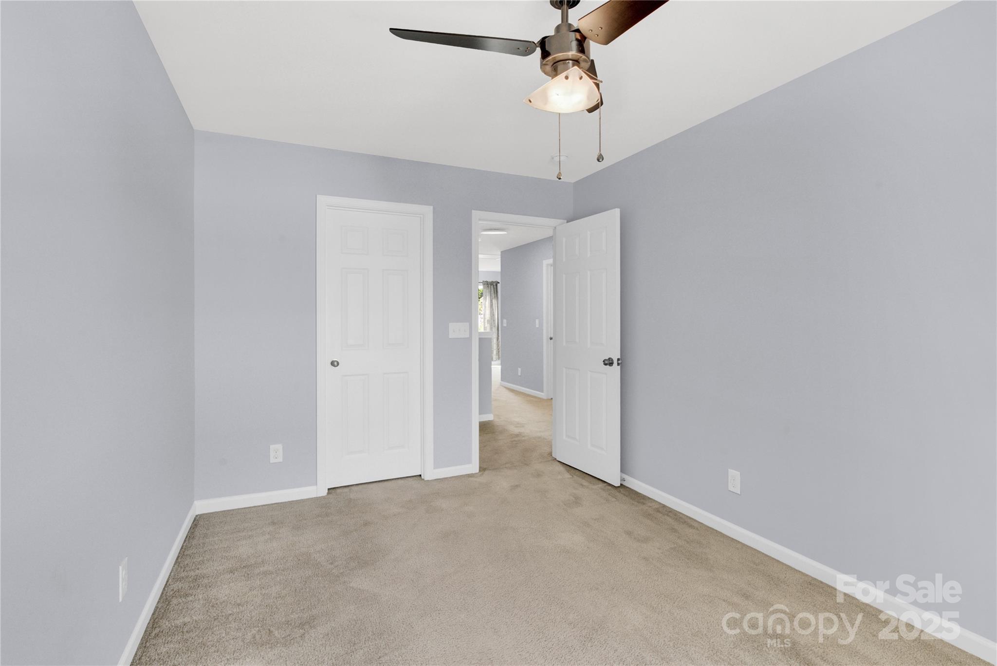 12418 Downy Birch Road Charlotte, NC 28227 - Photo 29 of 37 en empty room with a ceiling fan and a chandelier fan
