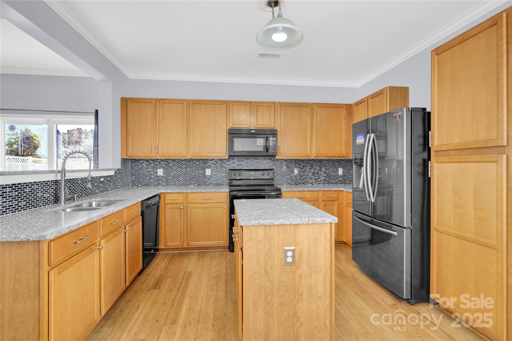 12418 Downy Birch Road Charlotte, NC 28227 - Photo 8 of 37 a kitchen with granite countertop a refrigerator and a sink