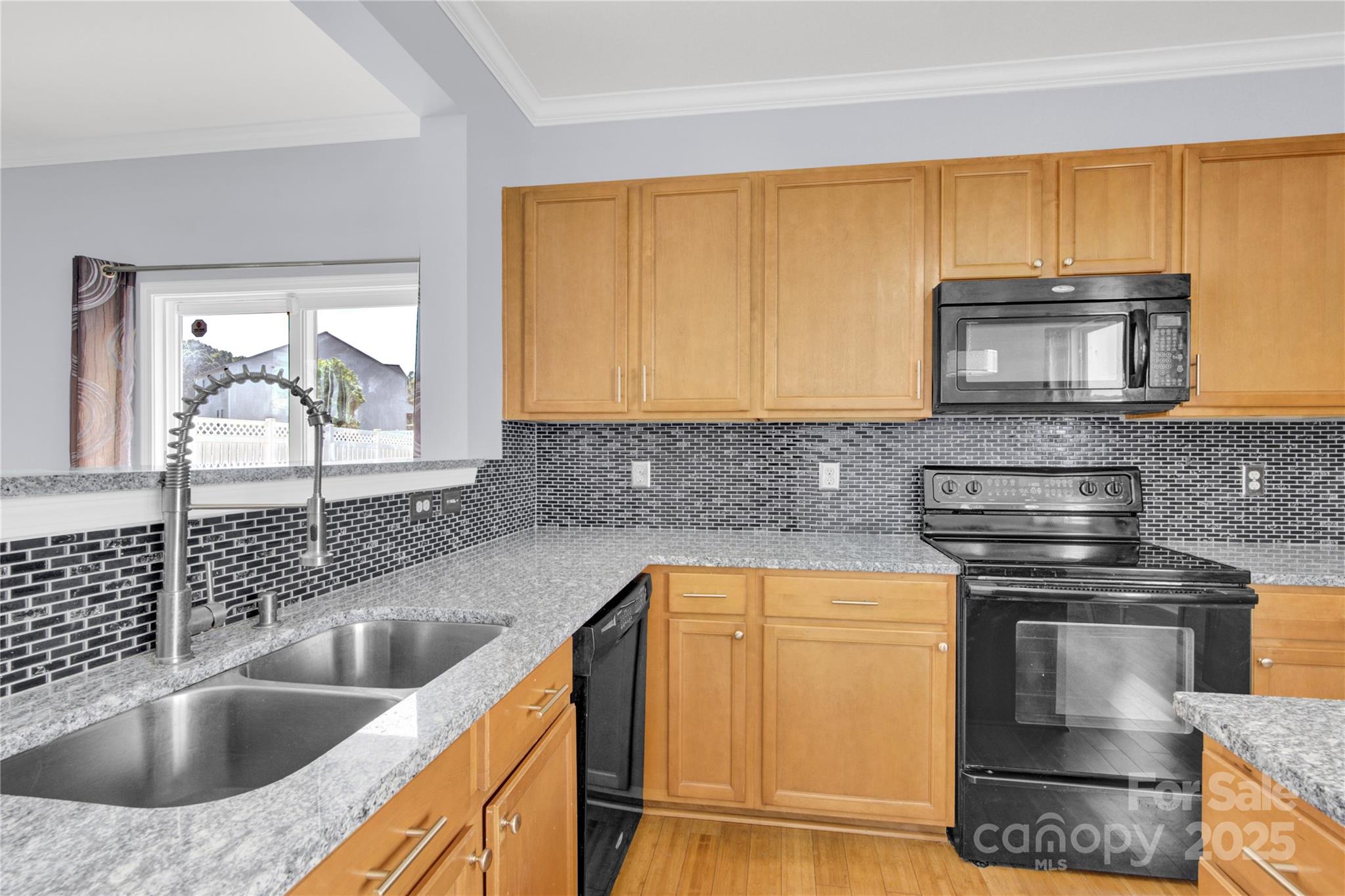 12418 Downy Birch Road Charlotte, NC 28227 - Photo 9 of 37 a kitchen with a sink and a microwave