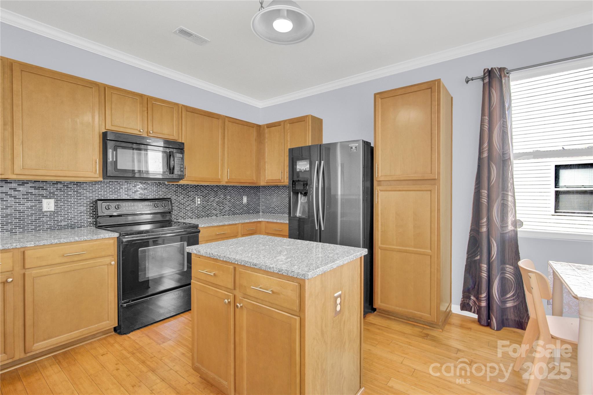 12418 Downy Birch Road Charlotte, NC 28227 - Photo 10 of 37 a kitchen with stainless steel appliances granite countertop a sink stove and refrigerator