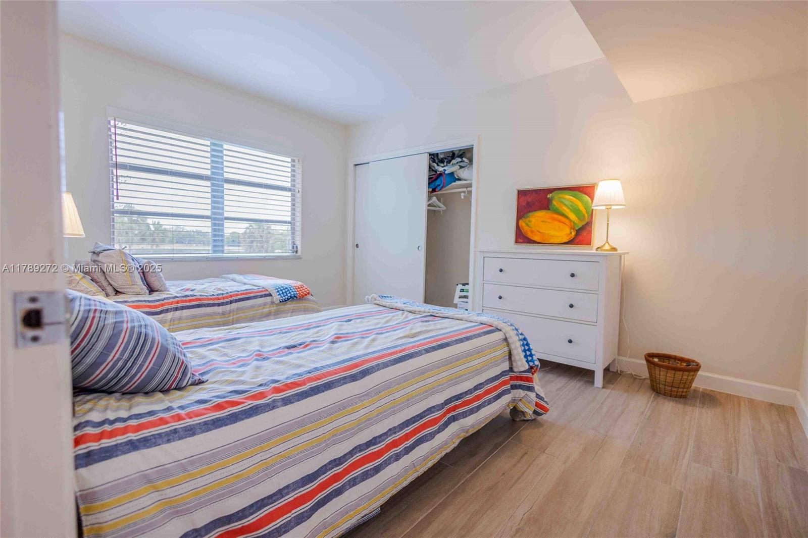 2751 North Palm Aire Drive, Unit 310 Pompano Beach, FL 33069 - Photo 17 of 70 a bedroom with a bed and painting on the wall