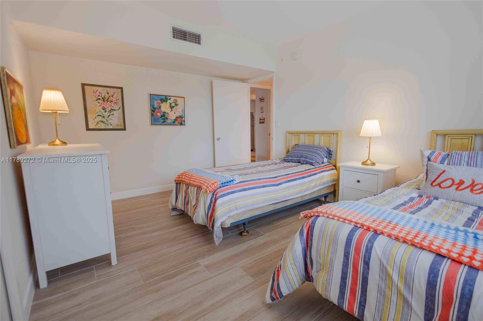 2751 North Palm Aire Drive, Unit 310 Pompano Beach, FL 33069 - Photo 21 of 70 a bedroom with two beds and a desk