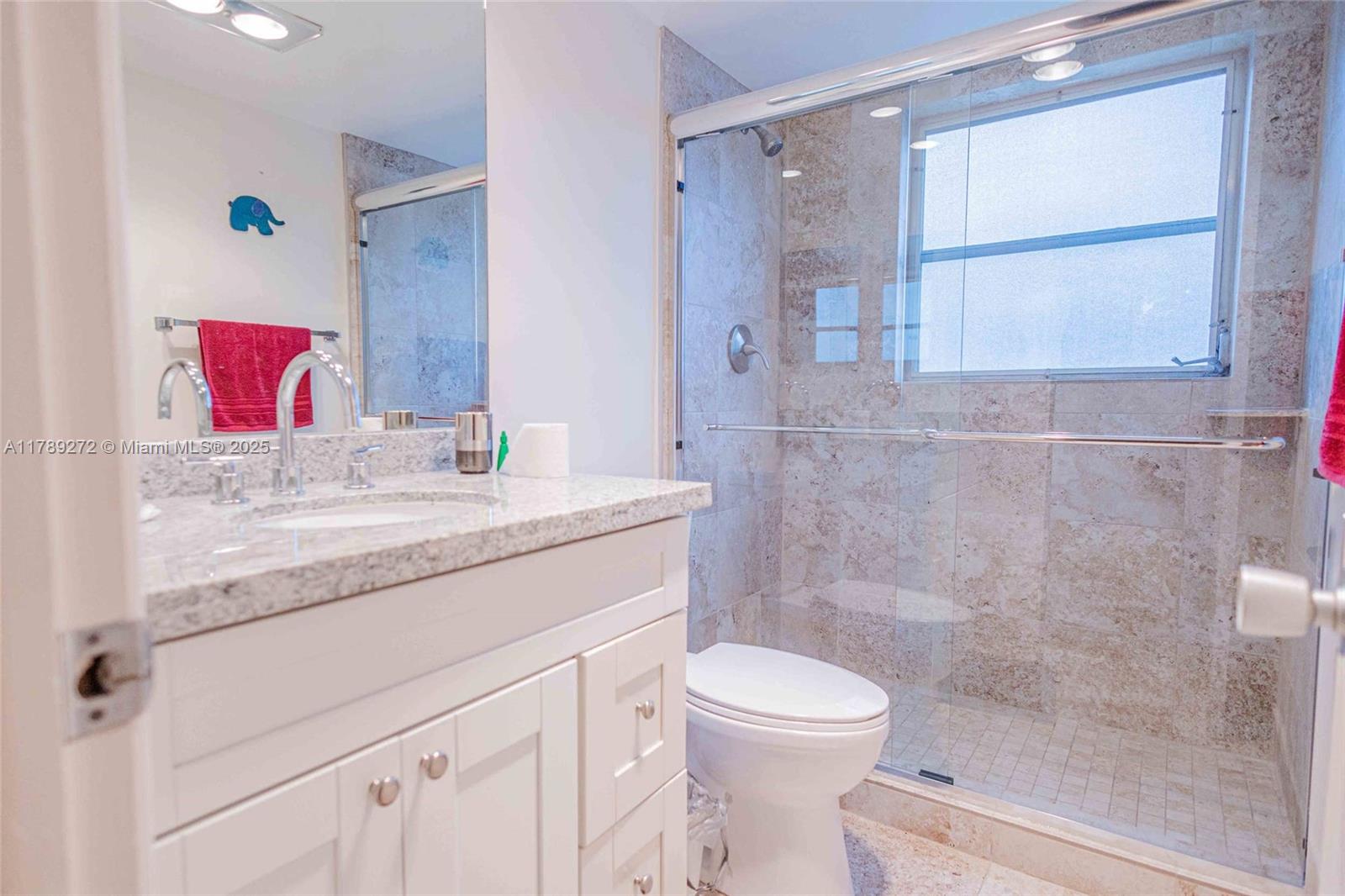 2751 North Palm Aire Drive, Unit 310 Pompano Beach, FL 33069 - Photo 22 of 70 a bathroom with a granite countertop sink a toilet and shower