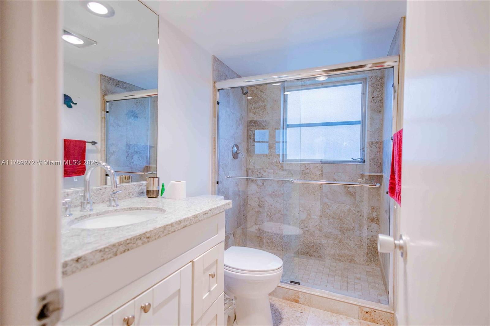 2751 North Palm Aire Drive, Unit 310 Pompano Beach, FL 33069 - Photo 23 of 70 a bathroom with a granite countertop sink toilet and shower