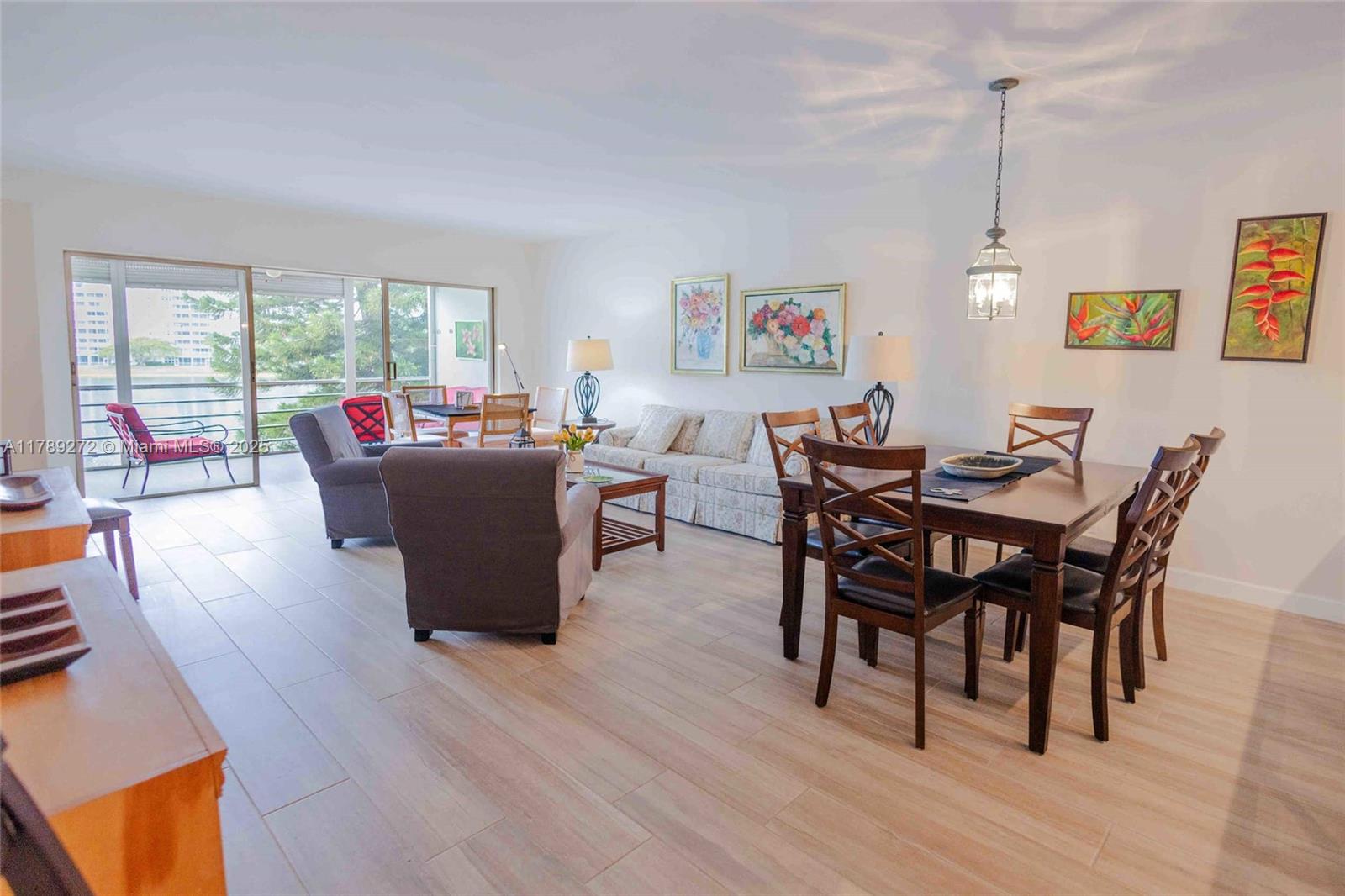 2751 North Palm Aire Drive, Unit 310 Pompano Beach, FL 33069 - Photo 25 of 70 a view of a dining room with furniture window and wooden floor