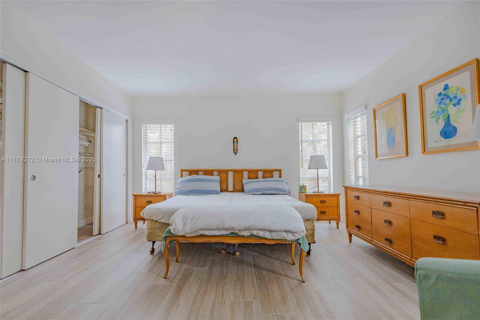 2751 North Palm Aire Drive, Unit 310 Pompano Beach, FL 33069 - Photo 29 of 70 a bedroom with a bed and wooden floor