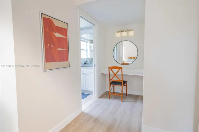 a dining room with furniture a chandelier and wooden floor