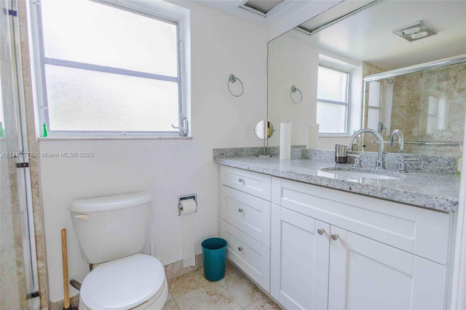 2751 North Palm Aire Drive, Unit 310 Pompano Beach, FL 33069 - Photo 33 of 70 a bathroom with a granite countertop toilet sink and mirror