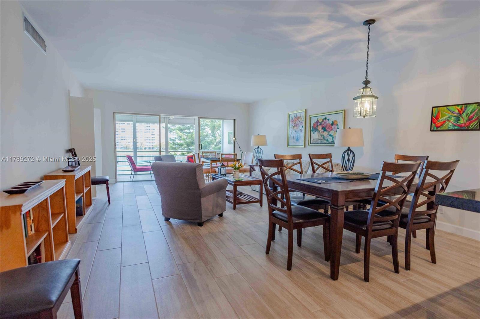 2751 North Palm Aire Drive, Unit 310 Pompano Beach, FL 33069 - Photo 38 of 70 a dining room with furniture a chandelier and wooden floor
