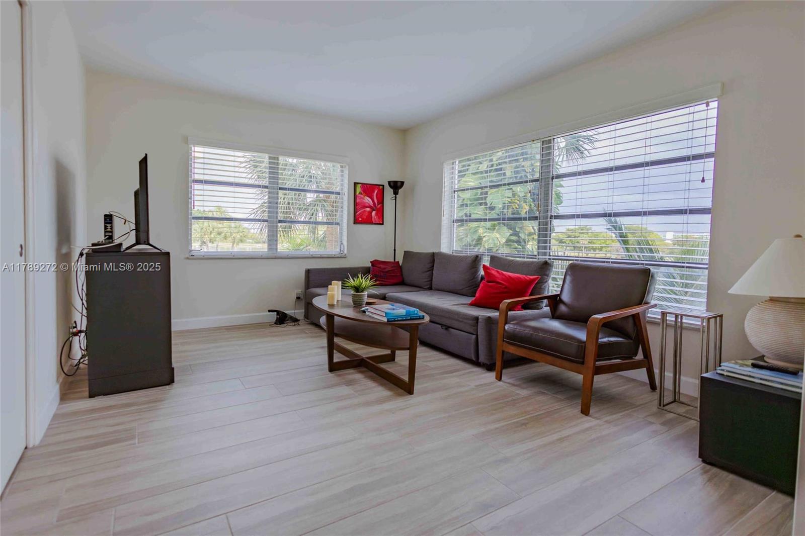 2751 North Palm Aire Drive, Unit 310 Pompano Beach, FL 33069 - Photo 39 of 70 a living room with furniture and a window