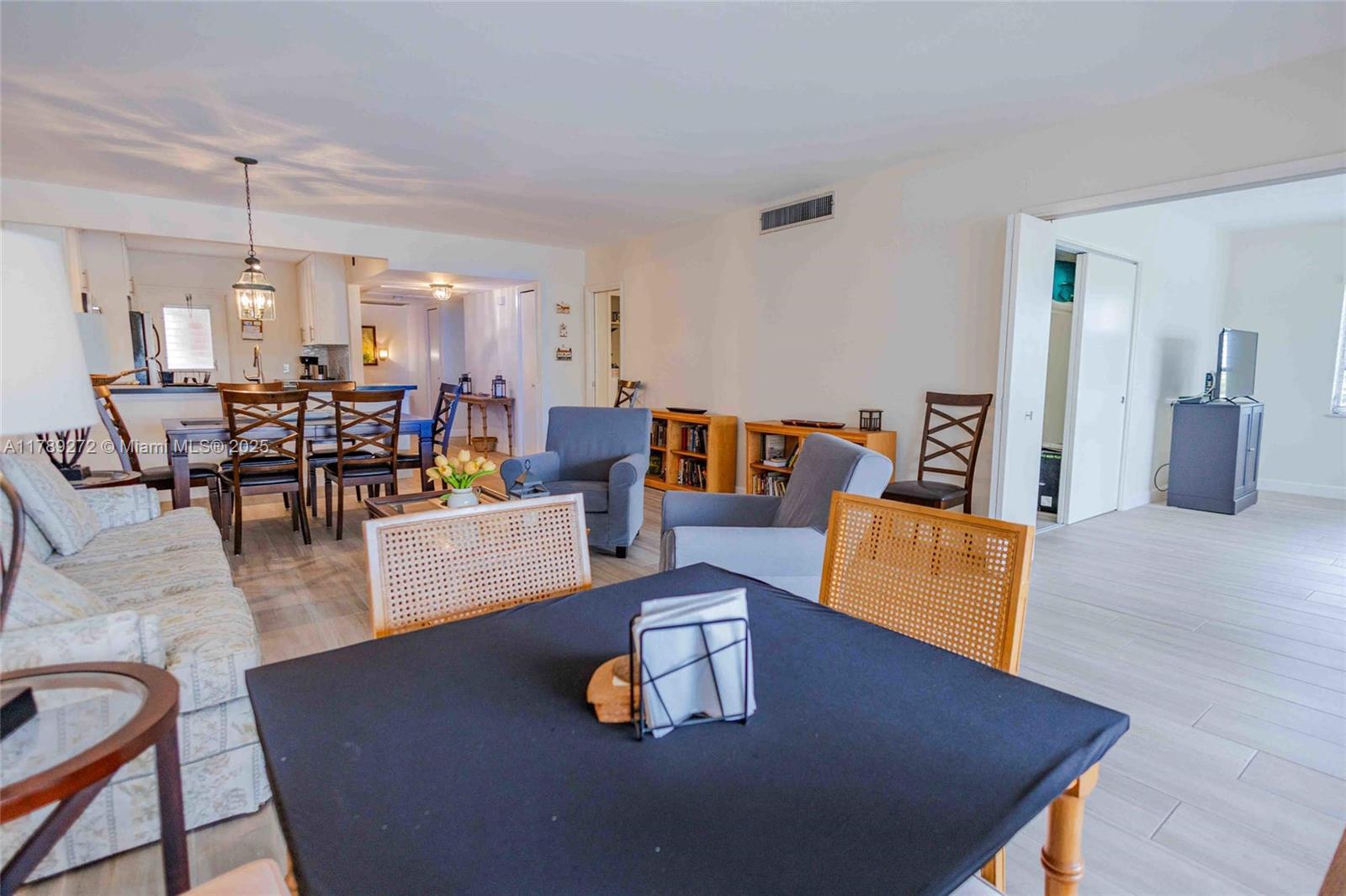 2751 North Palm Aire Drive, Unit 310 Pompano Beach, FL 33069 - Photo 40 of 70 a living room with furniture and a dining table with wooden floor