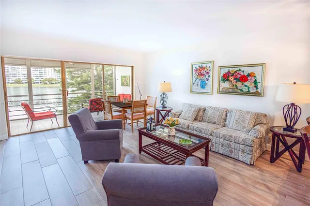 a living room with furniture and a floor to ceiling window