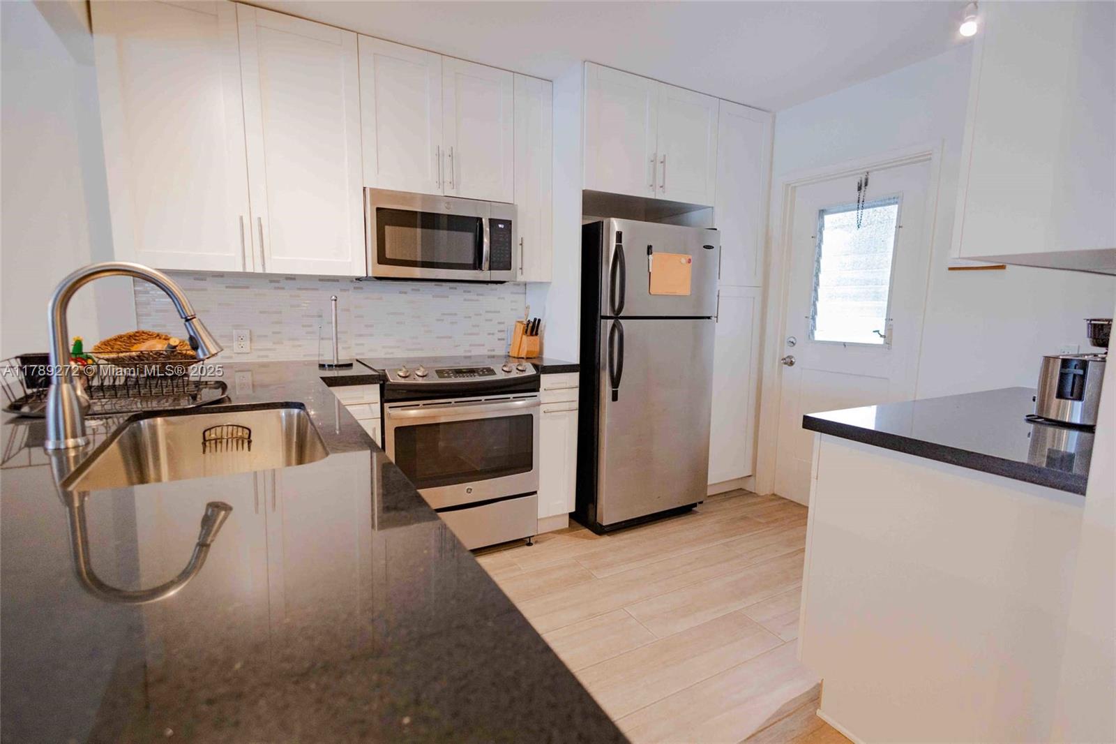 2751 North Palm Aire Drive, Unit 310 Pompano Beach, FL 33069 - Photo 41 of 70 a kitchen with stainless steel appliances granite countertop a refrigerator and a sink